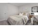 Bright bedroom showcasing a comfortable bed with soft linens, complemented by a functional desk and minimalist wall decor at 1419 5Th Street Ne Dr, Hickory, NC 28601