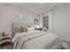 Well-lit bedroom features a cozy bed, a functional desk, and tasteful decor for a comfortable and stylish space at 1419 5Th Street Ne Dr, Hickory, NC 28601