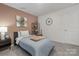 Charming bedroom with carpet, natural light, guitar art and picture accent wall at 1419 5Th Street Ne Dr, Hickory, NC 28601