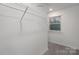 Spacious walk-in closet with ample shelving and storage space, illuminated by natural light from a nearby window at 1419 5Th Street Ne Dr, Hickory, NC 28601