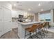 Bright kitchen featuring white cabinets, stainless steel appliances, and a large island with seating, perfect for entertaining at 1419 5Th Street Ne Dr, Hickory, NC 28601