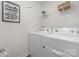 Functional laundry area equipped with modern washer and dryer, complemented by shelving for storage and a fun laundry sign at 1419 5Th Street Ne Dr, Hickory, NC 28601