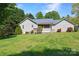 Expansive backyard featuring lush green lawn and the rear of the house with a screened porch at 1537 Haupt Strasse None, Conover, NC 28613
