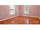This bedroom has wood floors, white trim, and two windows, providing natural light and a clean aesthetic at 1537 Haupt Strasse None, Conover, NC 28613