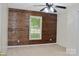 The bedroom features a striking wood accent wall and a ceiling fan, creating a warm and inviting atmosphere at 1537 Haupt Strasse None, Conover, NC 28613