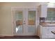 Bright kitchen featuring white cabinets, stainless appliances, and French doors to the outdoor deck at 1537 Haupt Strasse None, Conover, NC 28613