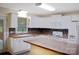 Spacious kitchen with white appliances, mosaic backsplash, and plenty of cabinet space at 1537 Haupt Strasse None, Conover, NC 28613