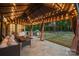 Charming outdoor patio with string lights, grill, and dining area, creating a perfect space for entertaining and relaxation at 1543 Ab Moore Jr Dr, Indian Trail, NC 28079