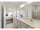 Bathroom featuring double sinks, modern fixtures, and a view into the adjacent main bedroom at 1543 Ab Moore Jr Dr, Indian Trail, NC 28079