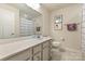 Bathroom showcasing a large vanity with ample storage space, a clean white toilet, and a shower with a patterned curtain at 1543 Ab Moore Jr Dr, Indian Trail, NC 28079