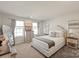 Bright bedroom featuring neutral colors, carpet flooring, and a well-decorated bed with stylish pillows at 1543 Ab Moore Jr Dr, Indian Trail, NC 28079