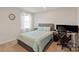 Cozy bedroom with a comfortable bed, workspace setup, and neutral-toned walls, providing a functional living space at 1543 Ab Moore Jr Dr, Indian Trail, NC 28079