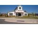 Community clubhouse featuring a modern farmhouse design, well-manicured landscaping, and inviting entrance at 1543 Ab Moore Jr Dr, Indian Trail, NC 28079