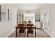 Bright dining area featuring a wooden table and chairs, built-in glass door cabinets, and ample natural light at 1543 Ab Moore Jr Dr, Indian Trail, NC 28079