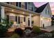 Inviting covered porch with rocking chairs and manicured landscaping gives this home great curb appeal at 1543 Ab Moore Jr Dr, Indian Trail, NC 28079