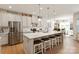 Bright, open kitchen featuring a large island with seating, stainless steel appliances, and stylish white cabinetry at 1543 Ab Moore Jr Dr, Indian Trail, NC 28079