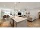 Bright living room features an open-concept layout with a view of the kitchen and dining area at 1543 Ab Moore Jr Dr, Indian Trail, NC 28079