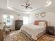 Spacious main bedroom with a decorative tray ceiling, ceiling fan, plush rug, and comfortable king-sized bed at 1543 Ab Moore Jr Dr, Indian Trail, NC 28079