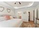 Well-lit main bedroom with a view into the ensuite bathroom; highlights a decorative tray ceiling and ceiling fan at 1543 Ab Moore Jr Dr, Indian Trail, NC 28079