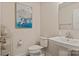 Well-lit powder room features a pedestal sink, toilet, and stylish decor at 1543 Ab Moore Jr Dr, Indian Trail, NC 28079