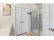 Neutral colored bathroom showcasing a glass shower enclosure, linen closet, and clean, modern fixtures at 1543 Ab Moore Jr Dr, Indian Trail, NC 28079