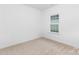 Empty bedroom with a large window and neutral carpet at 1615 Martin Ave, Gastonia, NC 28052