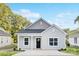 Charming single-story home with light gray siding, black front door, and manicured landscaping at 1615 Martin Ave, Gastonia, NC 28052