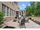 A cozy brick-paved backyard with Adirondack chairs, fire pit and string lights at 16532 Flintrock Falls Ln, Charlotte, NC 28278
