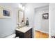 Stylish half bathroom with a designer mirror and modern vanity at 16532 Flintrock Falls Ln, Charlotte, NC 28278