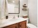 This bathroom features a vanity with wooden cabinets, open shelving, and neutral color palette at 16532 Flintrock Falls Ln, Charlotte, NC 28278