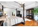 This luxurious main bedroom features a four-poster bed and a decorative armoire at 16532 Flintrock Falls Ln, Charlotte, NC 28278