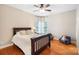 Cozy bedroom with a ceiling fan, light-filled windows, and hardwood floors at 16532 Flintrock Falls Ln, Charlotte, NC 28278