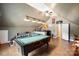 This bonus room features a pool table, bar and is well lit with a ceiling fan to keep you cool at 16532 Flintrock Falls Ln, Charlotte, NC 28278
