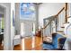 Light-filled foyer showcasing hardwood floors, soaring ceilings, and an elegant staircase with wood banister at 16532 Flintrock Falls Ln, Charlotte, NC 28278
