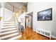 Bright foyer with a grand staircase, hardwood floors, and elegant decor at 16532 Flintrock Falls Ln, Charlotte, NC 28278