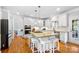 Gourmet kitchen featuring white cabinets, stainless steel appliances, a center island and hardwood floors at 16532 Flintrock Falls Ln, Charlotte, NC 28278