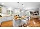 Spacious kitchen featuring an island with seating, and an adjacent dining area with natural light at 16532 Flintrock Falls Ln, Charlotte, NC 28278