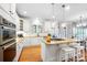 Modern kitchen with white cabinets, granite countertops, stainless steel appliances, and a central island at 16532 Flintrock Falls Ln, Charlotte, NC 28278