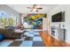 Fun living room with hardwood floors and a mural accent wall plus large windows for tons of natural light at 16532 Flintrock Falls Ln, Charlotte, NC 28278
