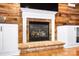 Close-up of a cozy living room with a wood-paneled accent wall, fireplace, and built-in cabinetry at 16532 Flintrock Falls Ln, Charlotte, NC 28278