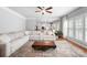 Spacious living room with a large sectional sofa, wood coffee table, and hardwood floors at 16532 Flintrock Falls Ln, Charlotte, NC 28278