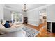 Inviting living room with hardwood floors, neutral walls, modern furniture, and large windows at 16532 Flintrock Falls Ln, Charlotte, NC 28278