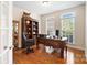 Home office boasts hardwood floors, natural light, and classic wood furnishings at 16532 Flintrock Falls Ln, Charlotte, NC 28278