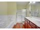 Bright bathroom with a double vanity, tub and a separate glass enclosed shower at 16746 Amberside E Rd, Cornelius, NC 28031