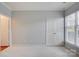 Neutral bedroom with double doors, window, and carpet floors at 16746 Amberside E Rd, Cornelius, NC 28031