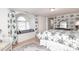 Comfortable bedroom features floral wallpaper, window seat, and decorative rug at 17333 Saranita Ln, Charlotte, NC 28278