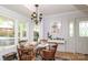 Cozy dining area with a glass-top table, seating for four, and natural light from surrounding windows at 17333 Saranita Ln, Charlotte, NC 28278