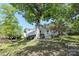Large home with ample deck space surrounded by mature trees and landscaping at 17333 Saranita Ln, Charlotte, NC 28278