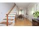 Inviting foyer with hardwood floors, staircase, and dining area with bay window at 17333 Saranita Ln, Charlotte, NC 28278
