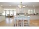 Spacious kitchen with white cabinetry, tile floors, and an island, perfect for cooking and gathering at 17333 Saranita Ln, Charlotte, NC 28278
